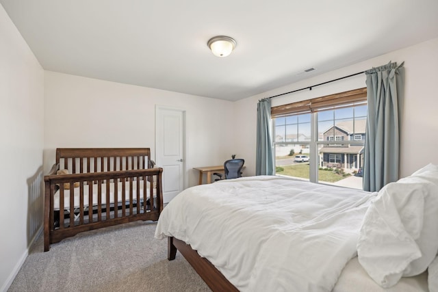 carpeted bedroom with visible vents and baseboards