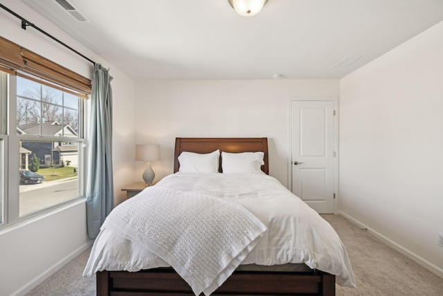 carpeted bedroom with visible vents and baseboards