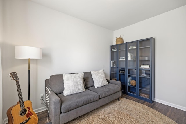 living area with baseboards and wood finished floors