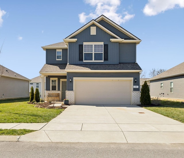 craftsman-style house featuring brick siding, a front lawn, concrete driveway, and a garage