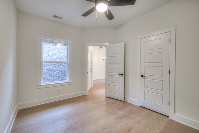 unfurnished bedroom with light wood-style flooring, visible vents, baseboards, and ceiling fan