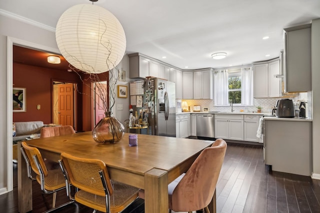 dining space with recessed lighting, dark wood-style floors, and crown molding