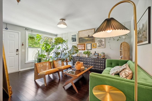 living area with baseboards and wood finished floors