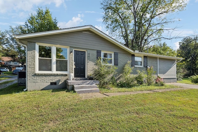 view of front facade featuring brick siding and a front lawn