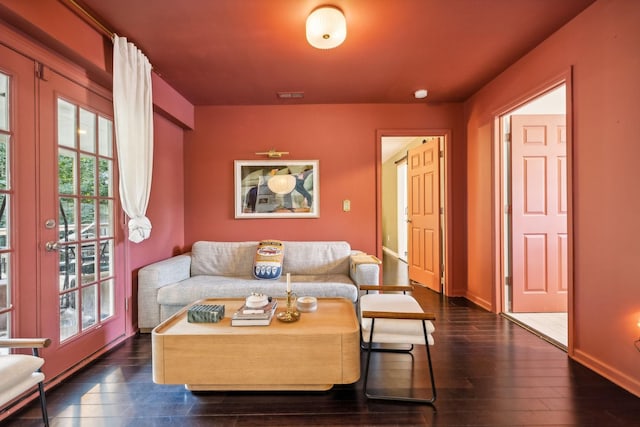 living room with visible vents, baseboards, and dark wood-style flooring