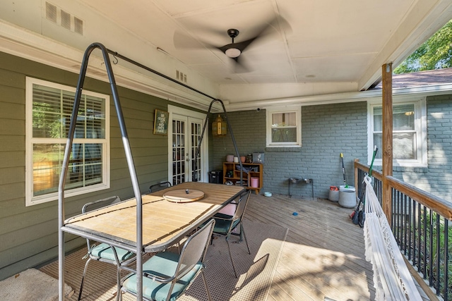 wooden deck featuring visible vents, french doors, and outdoor dining area