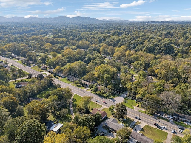 drone / aerial view featuring a mountain view and a forest view