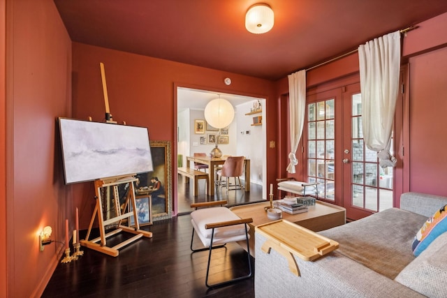 living area with french doors, baseboards, and wood finished floors