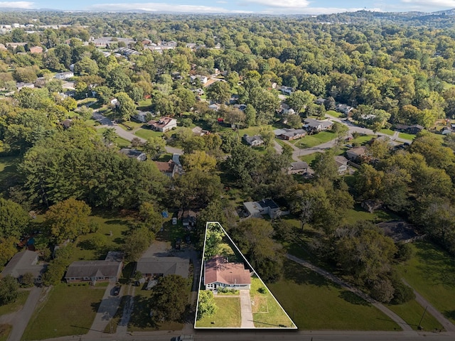 birds eye view of property featuring a wooded view and a residential view