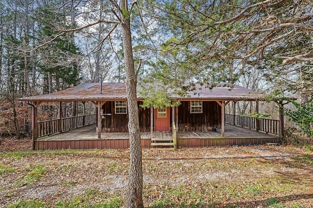 rear view of property with metal roof