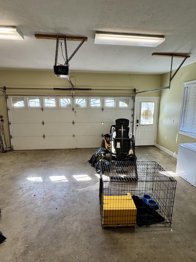 garage with baseboards and a garage door opener