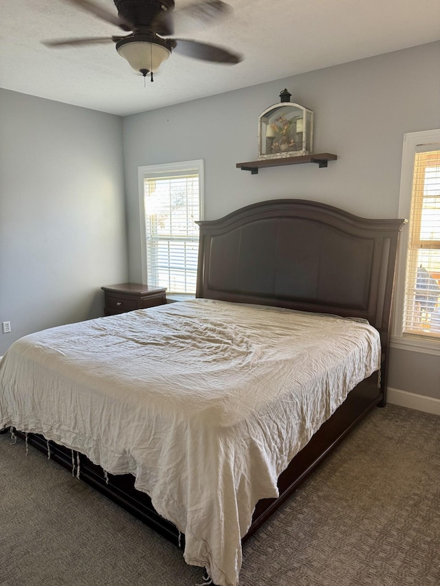 carpeted bedroom with baseboards and ceiling fan