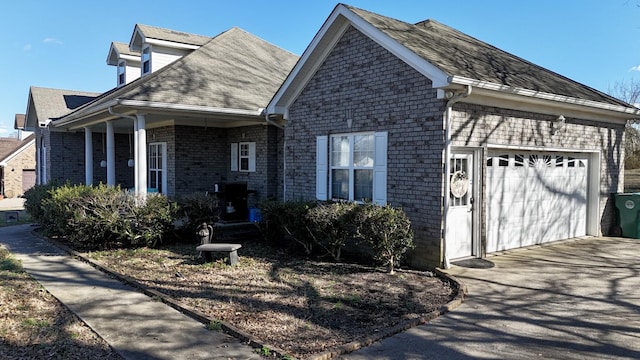 view of front of house featuring brick siding, concrete driveway, and a garage