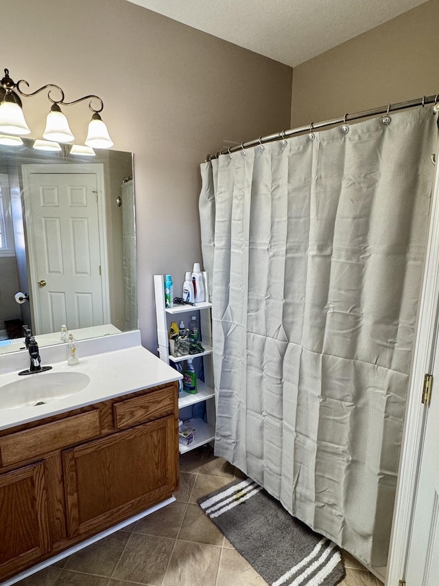 full bathroom featuring tile patterned floors and vanity