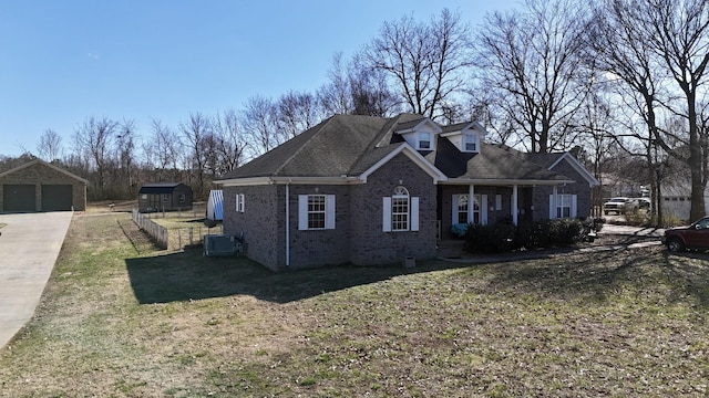 view of front of property featuring central air condition unit, an outbuilding, a garage, crawl space, and brick siding