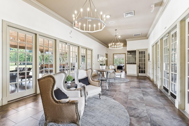 sitting room with a chandelier, visible vents, french doors, and ornamental molding