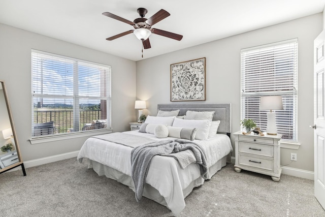 bedroom featuring a ceiling fan, baseboards, and light carpet