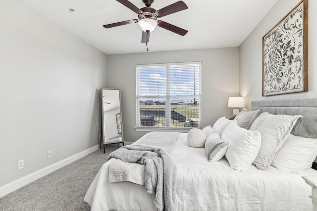 carpeted bedroom with ceiling fan and baseboards