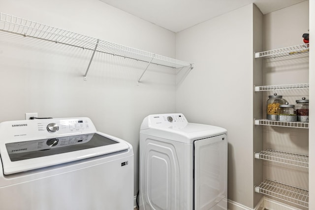 laundry room featuring laundry area and washing machine and clothes dryer