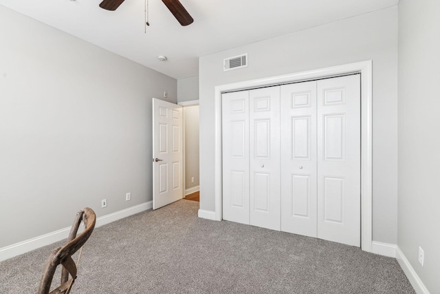 unfurnished bedroom with visible vents, baseboards, carpet floors, a closet, and a ceiling fan