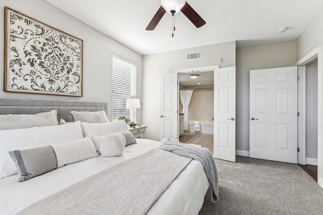 carpeted bedroom with baseboards, a ceiling fan, visible vents, and connected bathroom