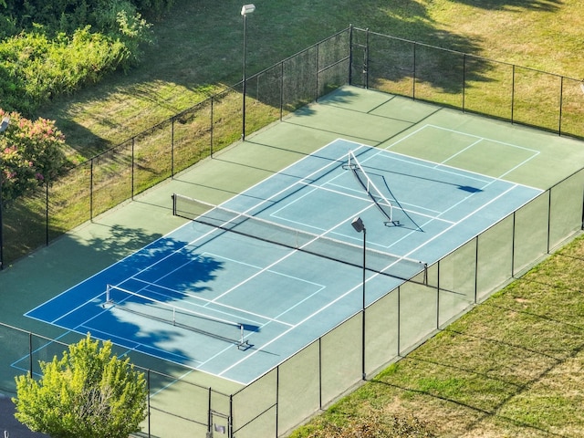 view of sport court featuring fence