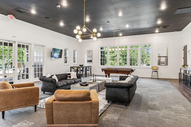 living area with visible vents, a notable chandelier, ornamental molding, billiards, and wood finished floors