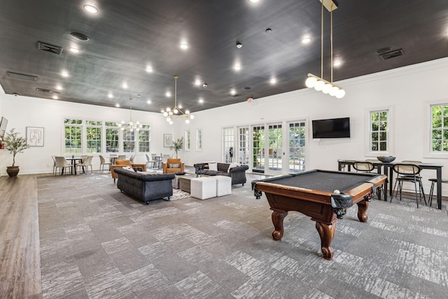 game room with a wealth of natural light, visible vents, and carpet floors