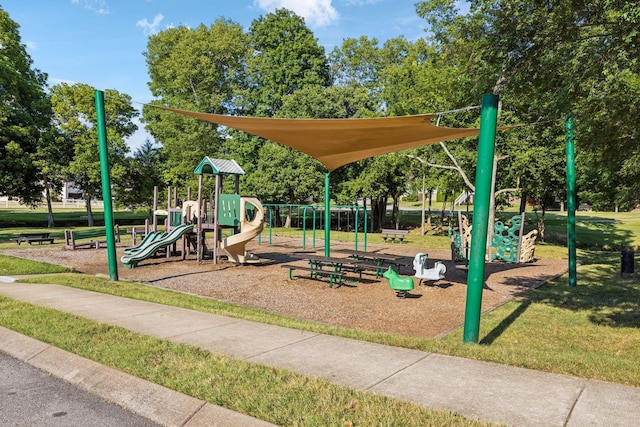 community jungle gym featuring a yard