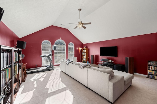 carpeted living area featuring baseboards, ceiling fan, and vaulted ceiling