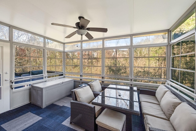 sunroom / solarium featuring ceiling fan