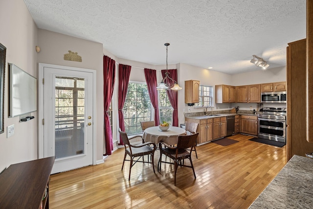 interior space featuring light wood-style flooring and a textured ceiling