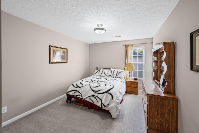 bedroom with carpet flooring, baseboards, visible vents, and a textured ceiling