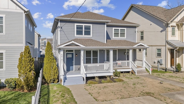 view of front of house with a porch and a shingled roof