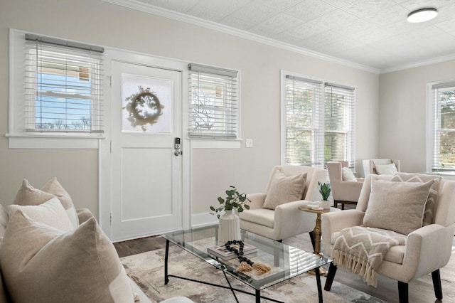 living room with baseboards, wood finished floors, and crown molding