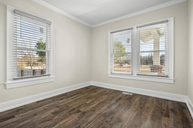 empty room featuring visible vents, baseboards, dark wood finished floors, and crown molding