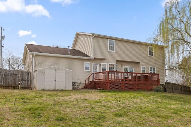 back of house featuring a wooden deck, a storage shed, a fenced backyard, a yard, and an outdoor structure