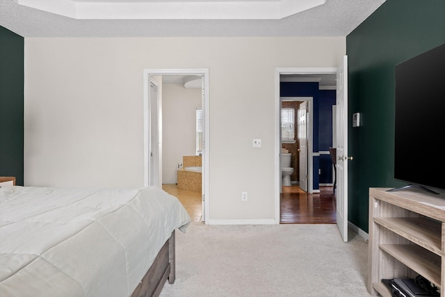 bedroom featuring a skylight, baseboards, carpet floors, and a textured ceiling