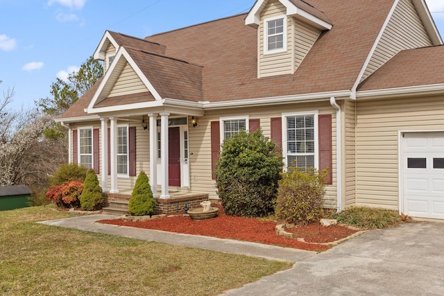 view of front of home with roof with shingles and an attached garage