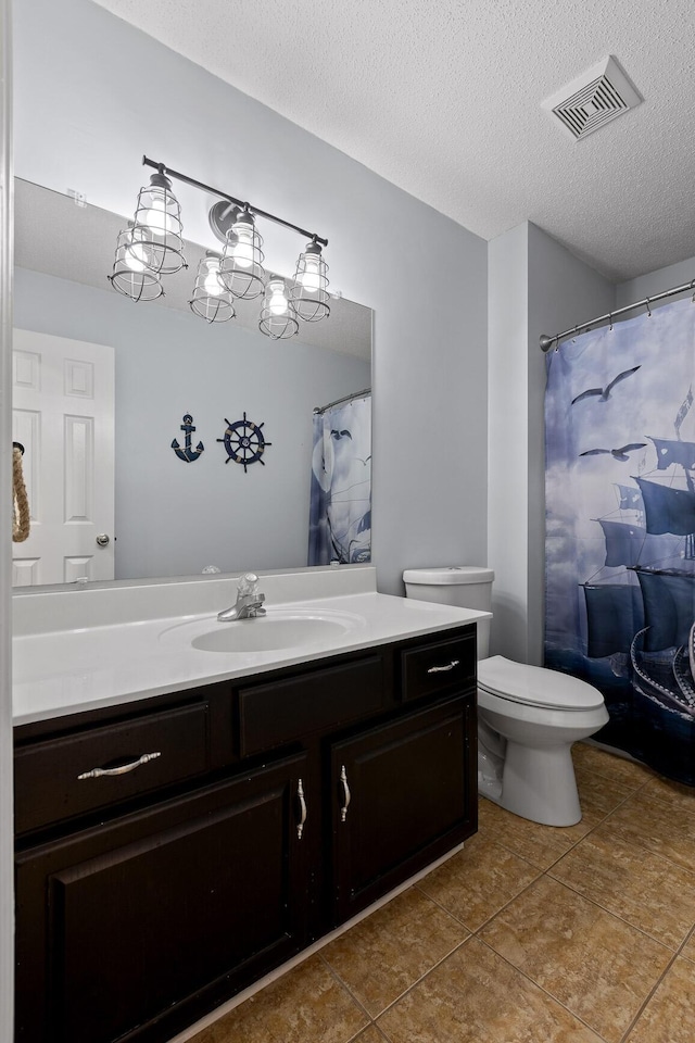 full bathroom with tile patterned floors, visible vents, a textured ceiling, and vanity