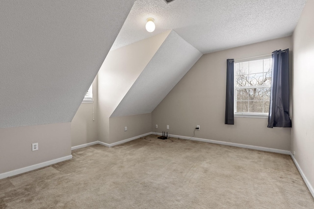 bonus room with carpet flooring, a textured ceiling, baseboards, and lofted ceiling