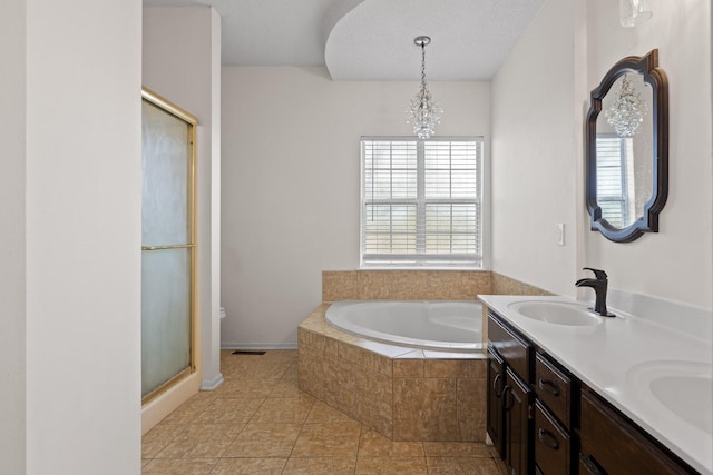 full bath with a sink, a stall shower, double vanity, and a bath