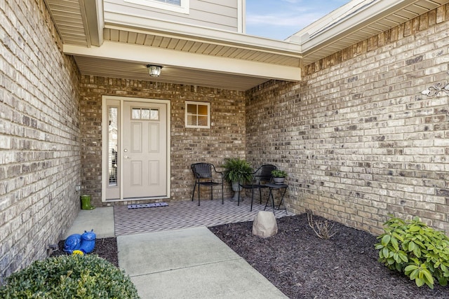 doorway to property featuring brick siding