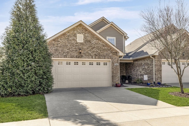 traditional home featuring brick siding, driveway, a garage, and roof with shingles