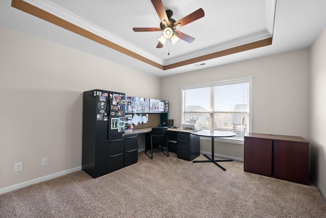 office with a tray ceiling, light carpet, visible vents, and crown molding