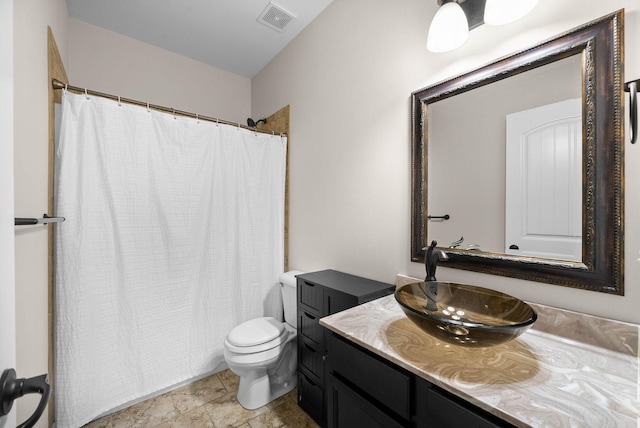 bathroom featuring vanity, curtained shower, toilet, and visible vents