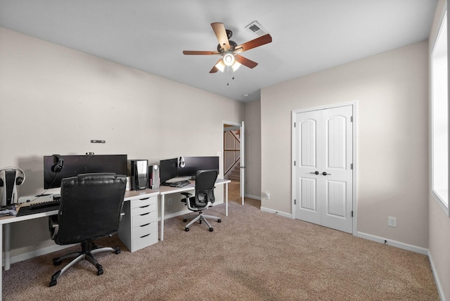 office with visible vents, light carpet, baseboards, and a ceiling fan