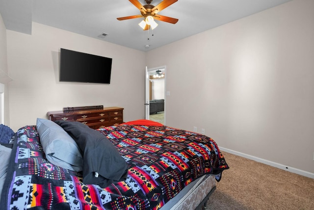 carpeted bedroom with visible vents, baseboards, and ceiling fan