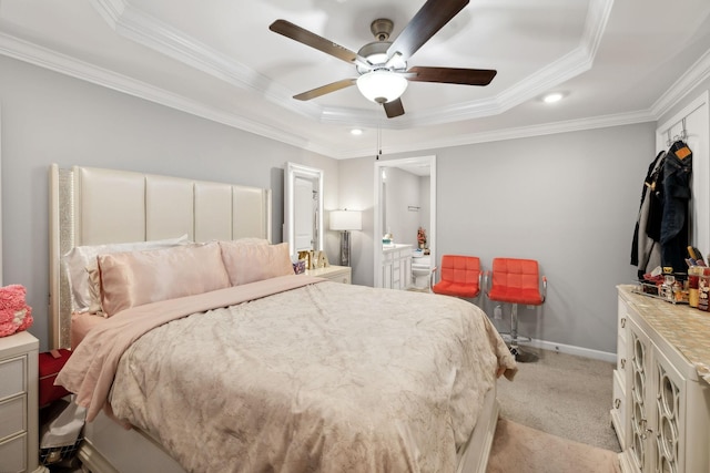 bedroom featuring ceiling fan, baseboards, a tray ceiling, ornamental molding, and light carpet