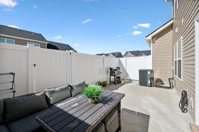 view of patio / terrace with grilling area, an outdoor living space, central AC, and a fenced backyard